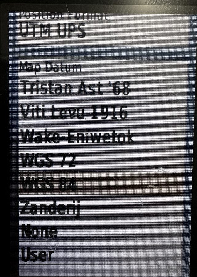 The map datum list on a Garmin GPSMAP 64st scrolled to the end, with WGS 84 highlighted among entries such as WGS 72, Wake-Eniwetok and Zanderij.