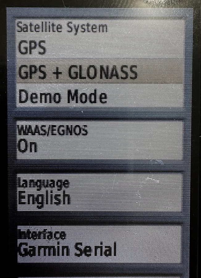 The system setup screen on a Garmin GPSMAP 64st showing Satellite System set to GPS plus GLONASS and WAAS/EGNOS switched on.